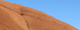 Climbers look tiny as they hike up Uluru