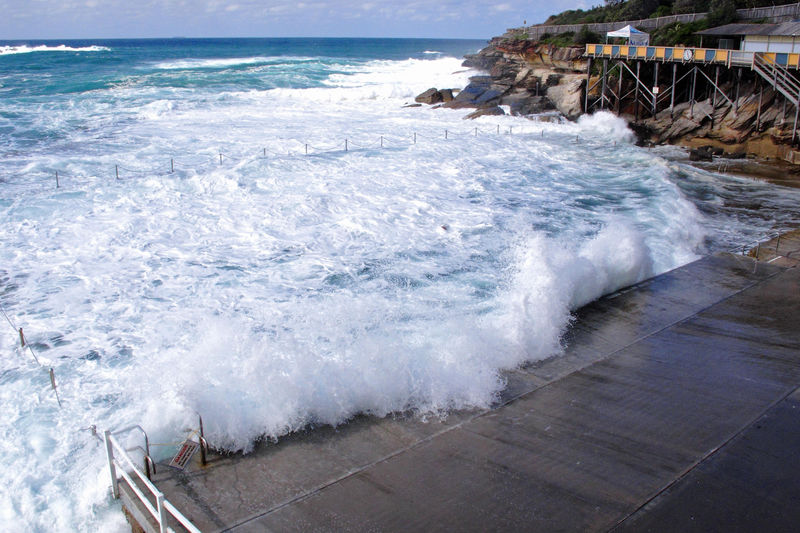Waves crash onto a shore of an ocean beath