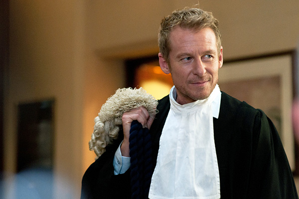 A shot of Australian TV's Cleaver Green with a lawyer wig over his shoulder, from the show Rake
