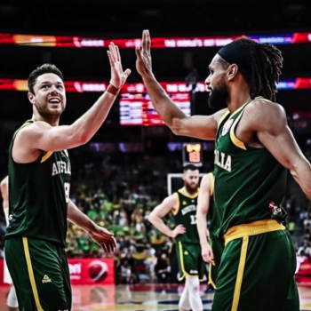 Two members of Australia's basketball team high five.